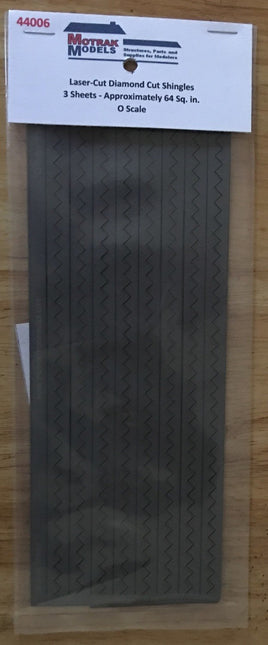 Packaged laser-cut diamond cut shingles on a wooden surface