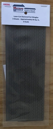 Packaged laser-cut diamond cut shingles on a wooden surface