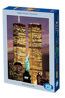 Jigsaw puzzle box featuring the World Trade Center and Statue of Liberty at night.