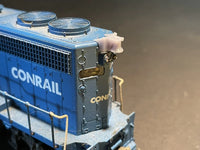 Close-up of a Conrail model train engine with detailed components.