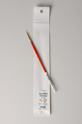 Paintbrush with 'Golden Taklon' label on a gray background