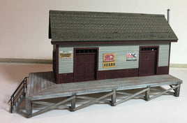 Model of a small building with a platform on a plain background