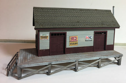 Model of a small building with a platform on a plain background