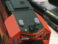 Close-up of a model train engine with '2094' on a blurred background
