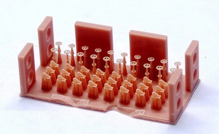 Red plastic model of a musical instrument with multiple holes on a white background