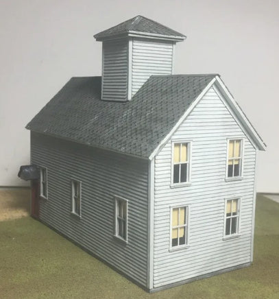 Model of a two-story building with a cupola on a plain background