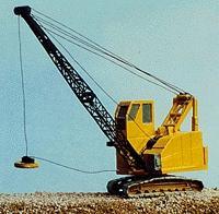 Yellow crane on a rocky terrain with a clear blue sky