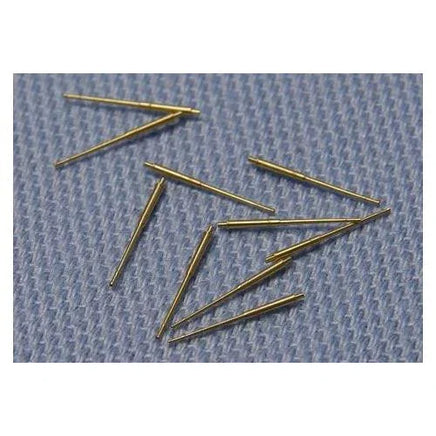 Gold-colored sewing needles on a textured blue fabric background