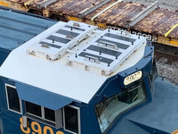 Blue train car with a white roof and yellow numbers on a railway track.