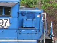 Blue train engine with number 97 and NS logo on a blurred natural background