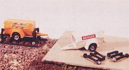Model train set with caution car and danger boxcar on a track.