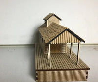 Model of a wooden cabin with a deck on a white background