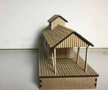 Model of a wooden cabin with a deck on a white background