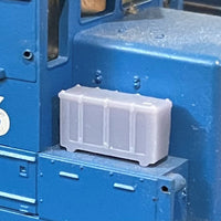Clear plastic container on a blue mechanical surface