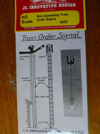 Model train order signal packaging with technical diagram and brand label on a wooden surface