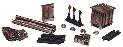 Collection of model train accessories including tracks, stations, and signals on a white background