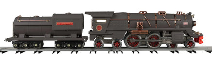 Model steam locomotive on tracks with a white background