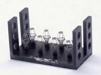 3D-printed metal components on a black holder against a white background