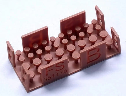 Brown plastic mold with letters and numbers on a white background