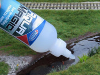 Bottle of Elmer's Magic Glue being used to fix a small stream.