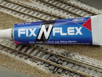 Tube of Fix N Flex adhesive on model train tracks