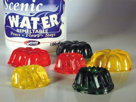 Colorful plastic moldings in front of a bottle labeled 'Scenic Water'.