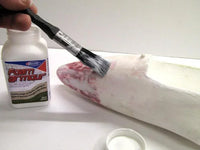 Foam Armour product with a brush and a white surface