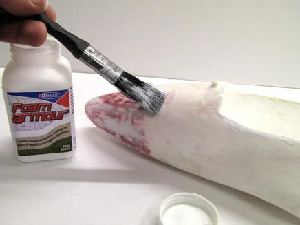 Foam Armour product with a brush and a white surface