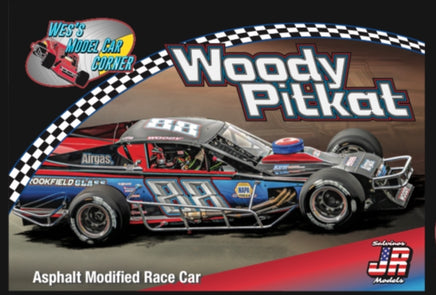 Model race car with 'Woody Pitkat' branding on a checkered background