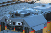 Close-up of a train engine number 1579 on railway tracks.