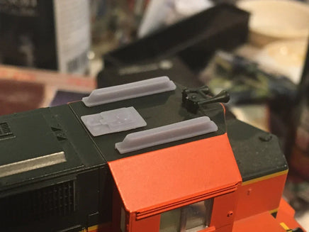 Model train with red and black details on a blurred background