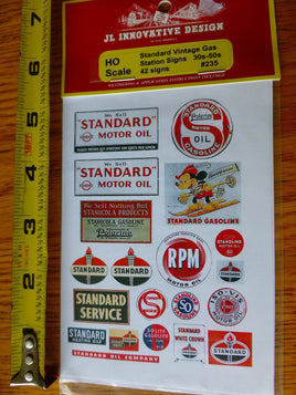 Sheet of vintage-style logos with a measuring tape for scale on a wooden surface