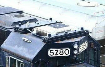Close-up of a vehicle with license plates '5280' and '6280'.