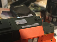 Close-up of a model train with detailed components on a blurred background