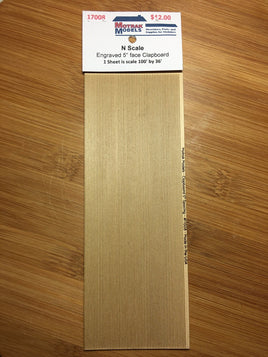 N-scale engraved 5" face clapboard on a wooden surface with a label.