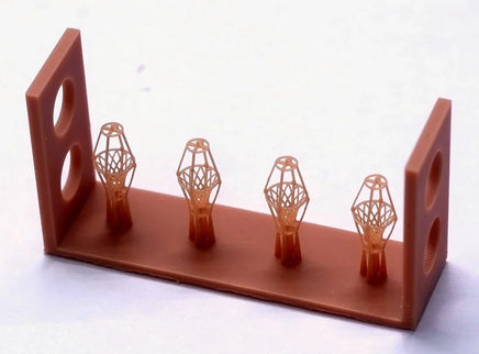 Red wooden holder with four wireframe-like objects on a white background