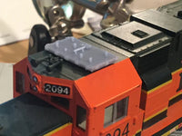 Close-up of a model train engine with '2094' on a blurred background