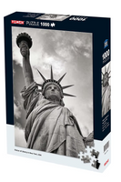 Jigsaw puzzle box featuring the Statue of Liberty against a cloudy sky
