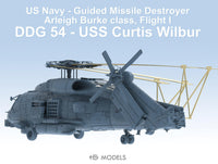 Model of a US Navy guided missile destroyer with text indicating it is a DDG 54 USS Curtis Wilbur.