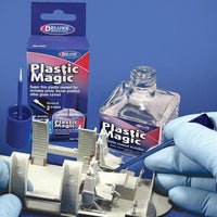 Plastic Magic modeling material with packaging and gloved hands on a blue background
