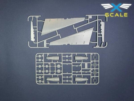 Model kit components with X-SCALE logo on a dark blue background