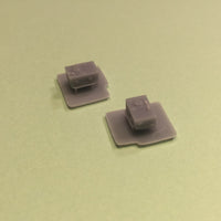 Two gray square objects on a green background