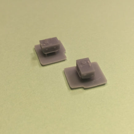 Two gray square objects on a green background