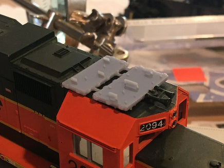 Close-up of a model train engine with a blurred background
