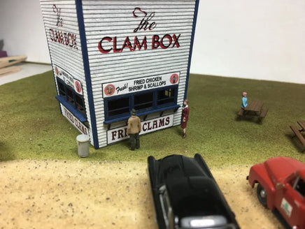Model of 'The Clam Box' restaurant with miniature people and cars on a scale model street.
