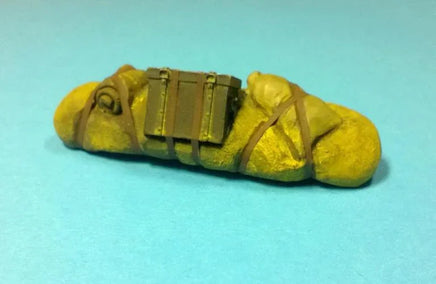 Yellow bread loaf with gold decorative band on a light blue background