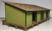 Model of a green and brown shed on a white background