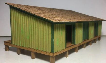 Model of a green and brown shed on a white background
