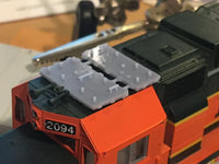 Close-up of a model train with '2094' on an orange and black engine.