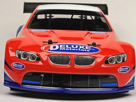Red race car with 'Deluxe Materials' branding on a gray background